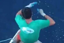 Terrifying moment great white shark lunges out of sea just inches away from fishermen as it devours tuna from line